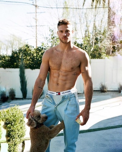 Matthew Noszka and his pet posing for a photoshoot